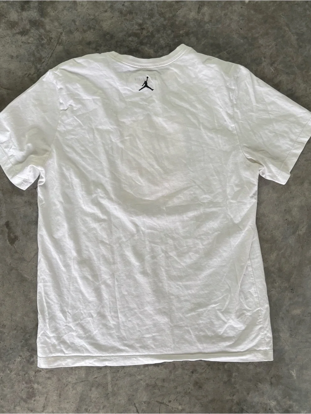 Jordan white graphic tee with Michael Jordan in a bumper car.